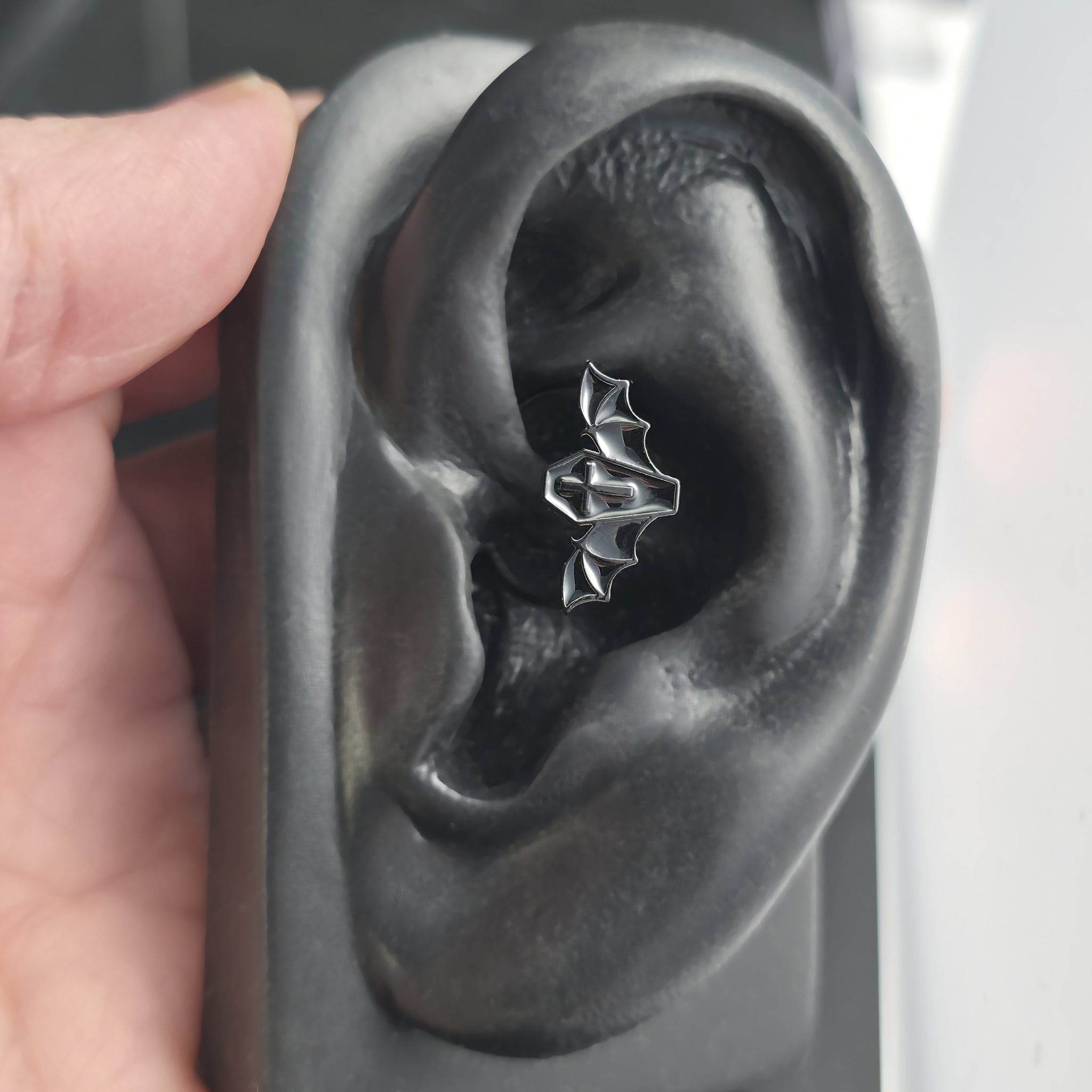 black coffin bat daith earring in ear