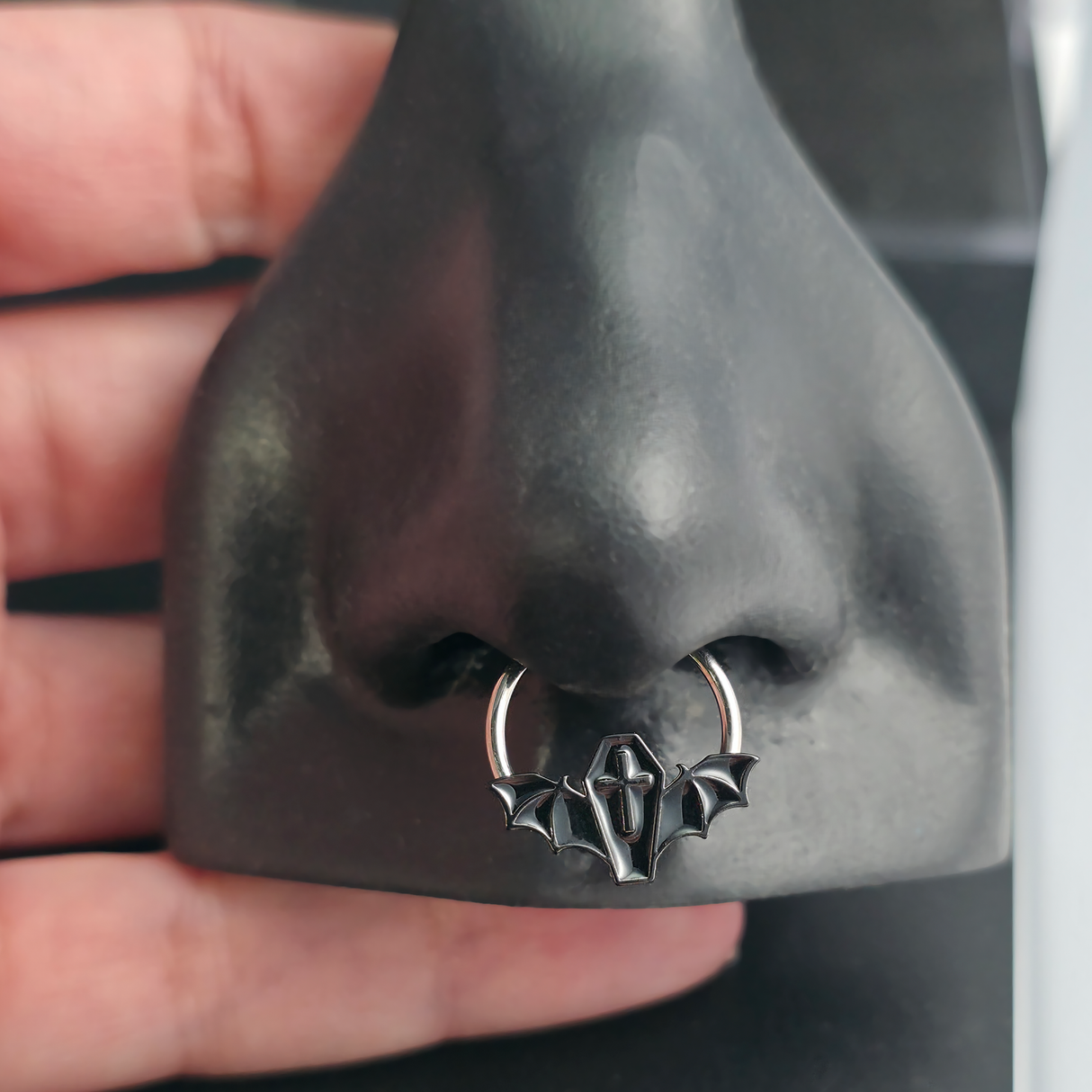 black coffin bat septum ring in nose
