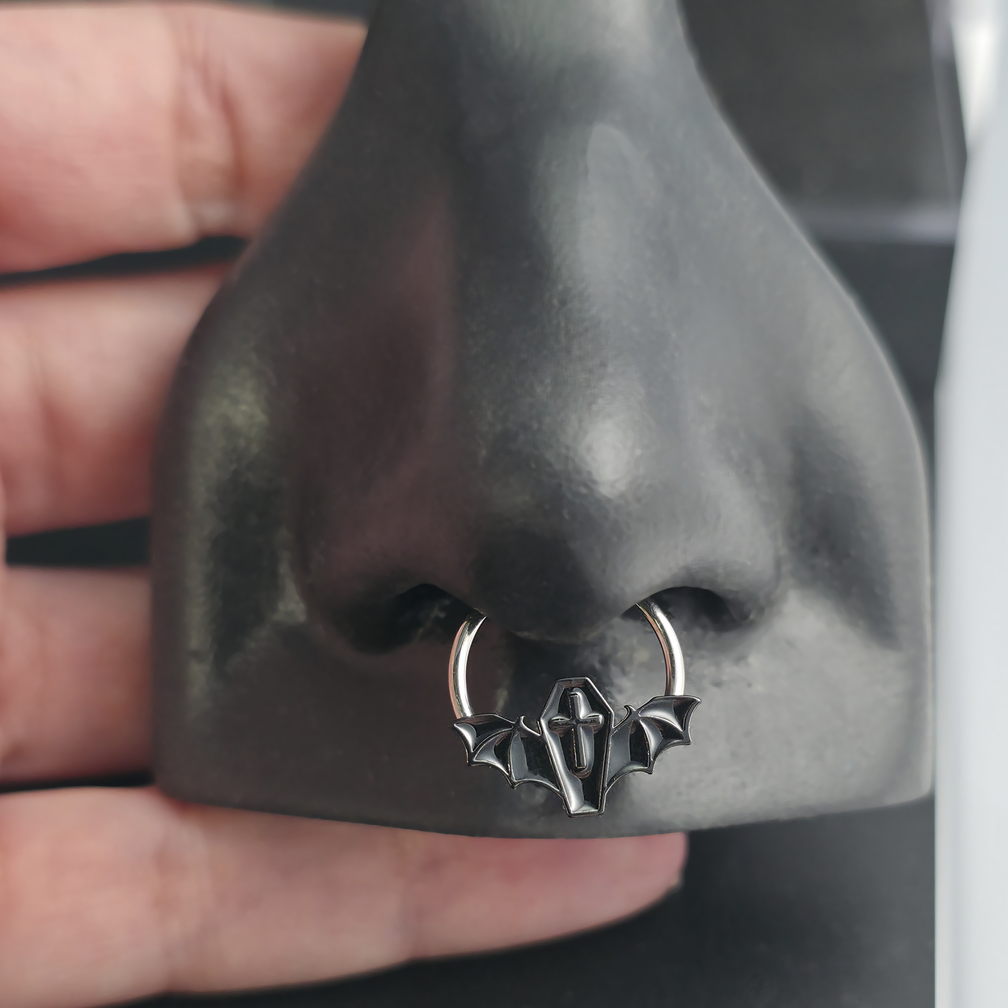 black coffin bat septum ring in nose