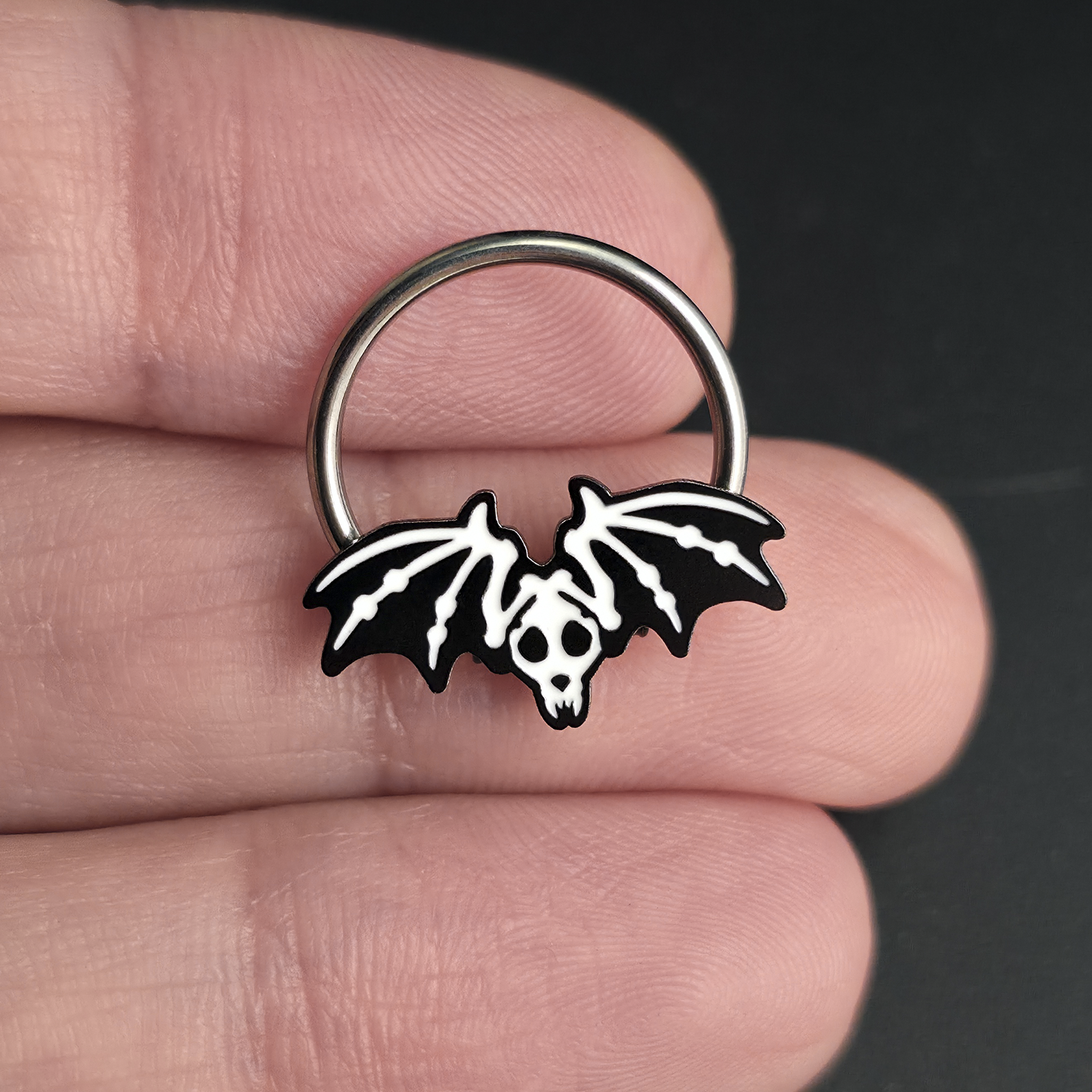 bat skeleton septum ring on hand