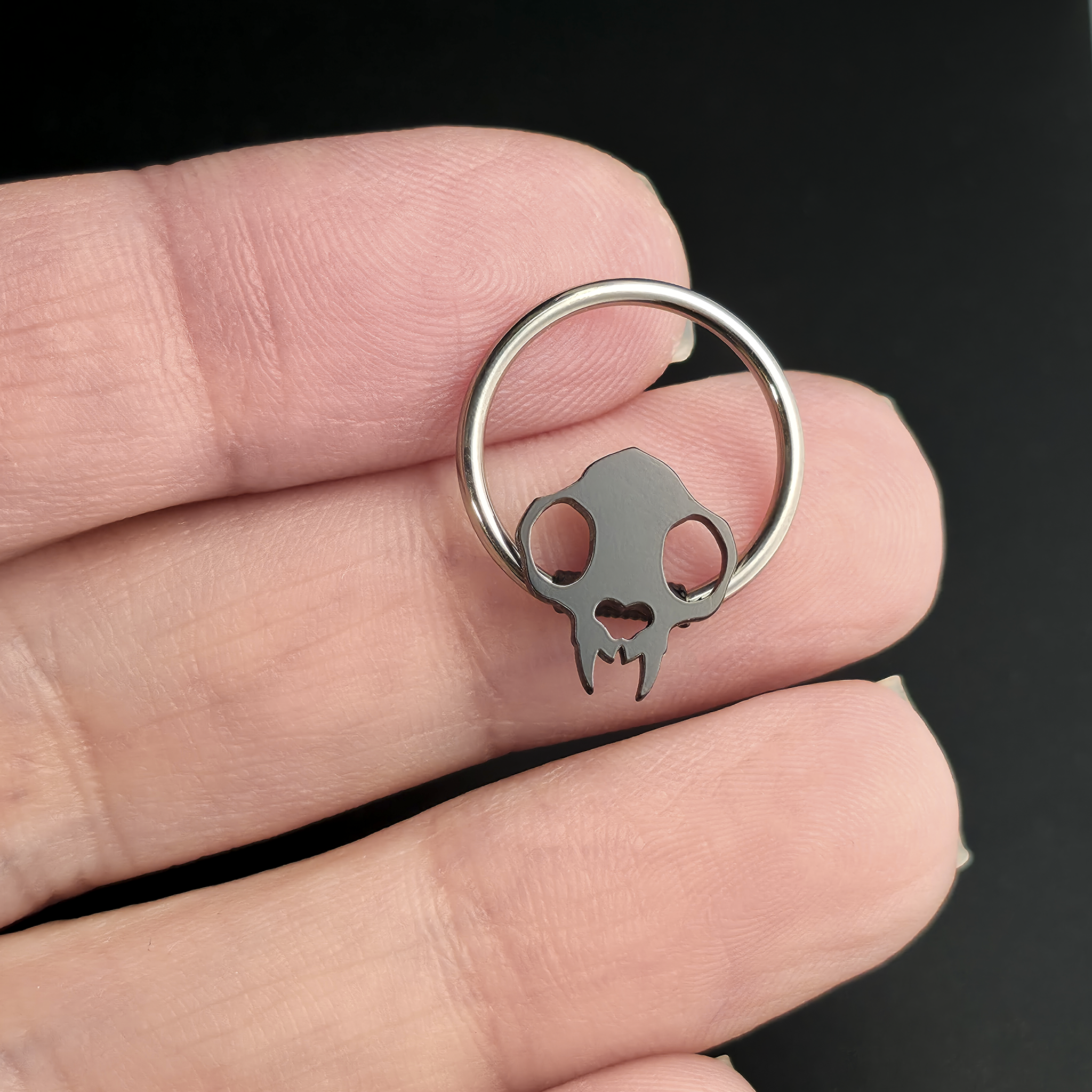 cat skull captive bead ring on hand