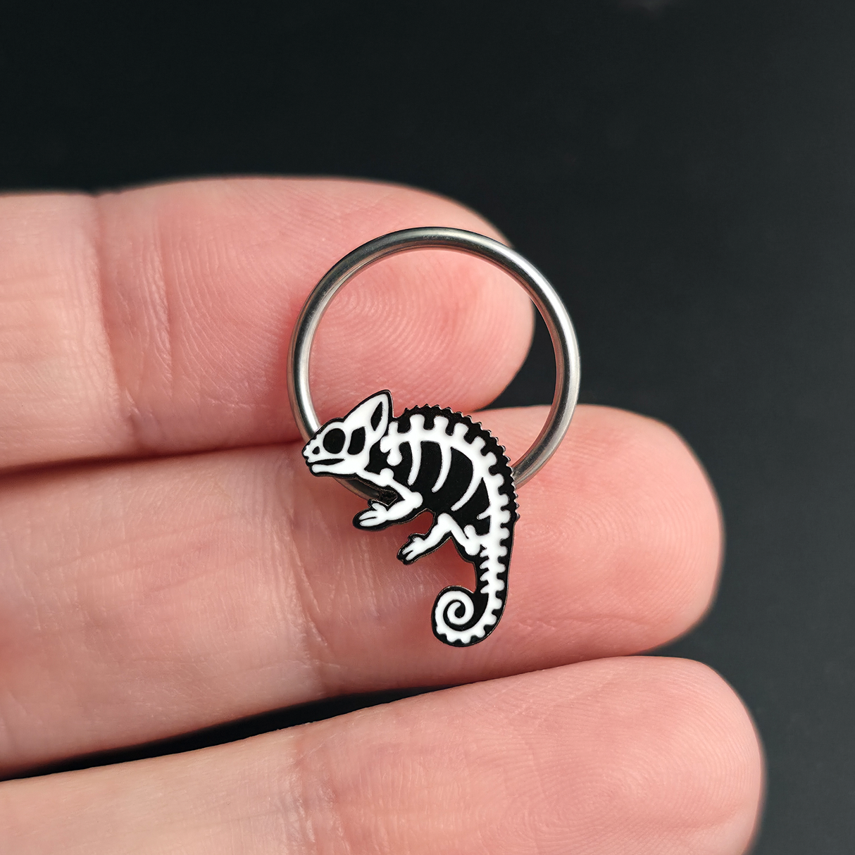 chameleon skeleton septum ring on hand