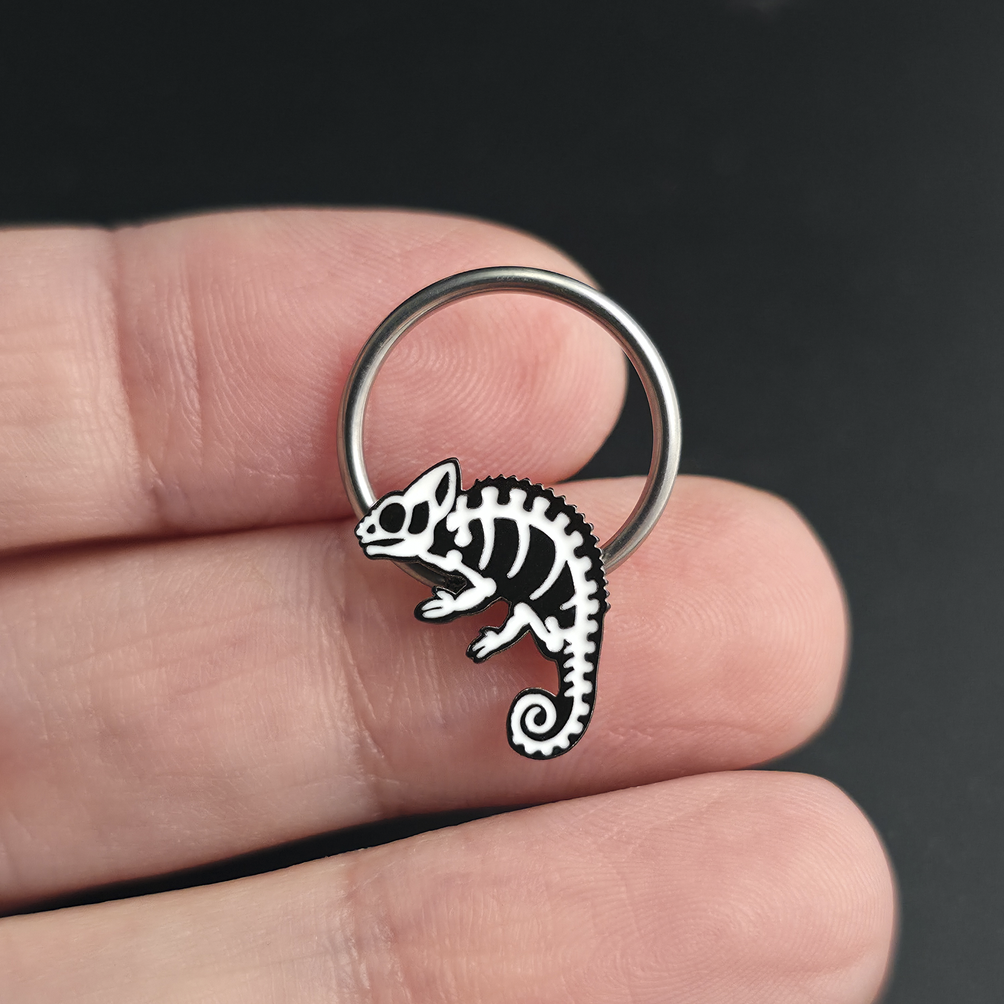 chameleon skeleton septum ring on hand