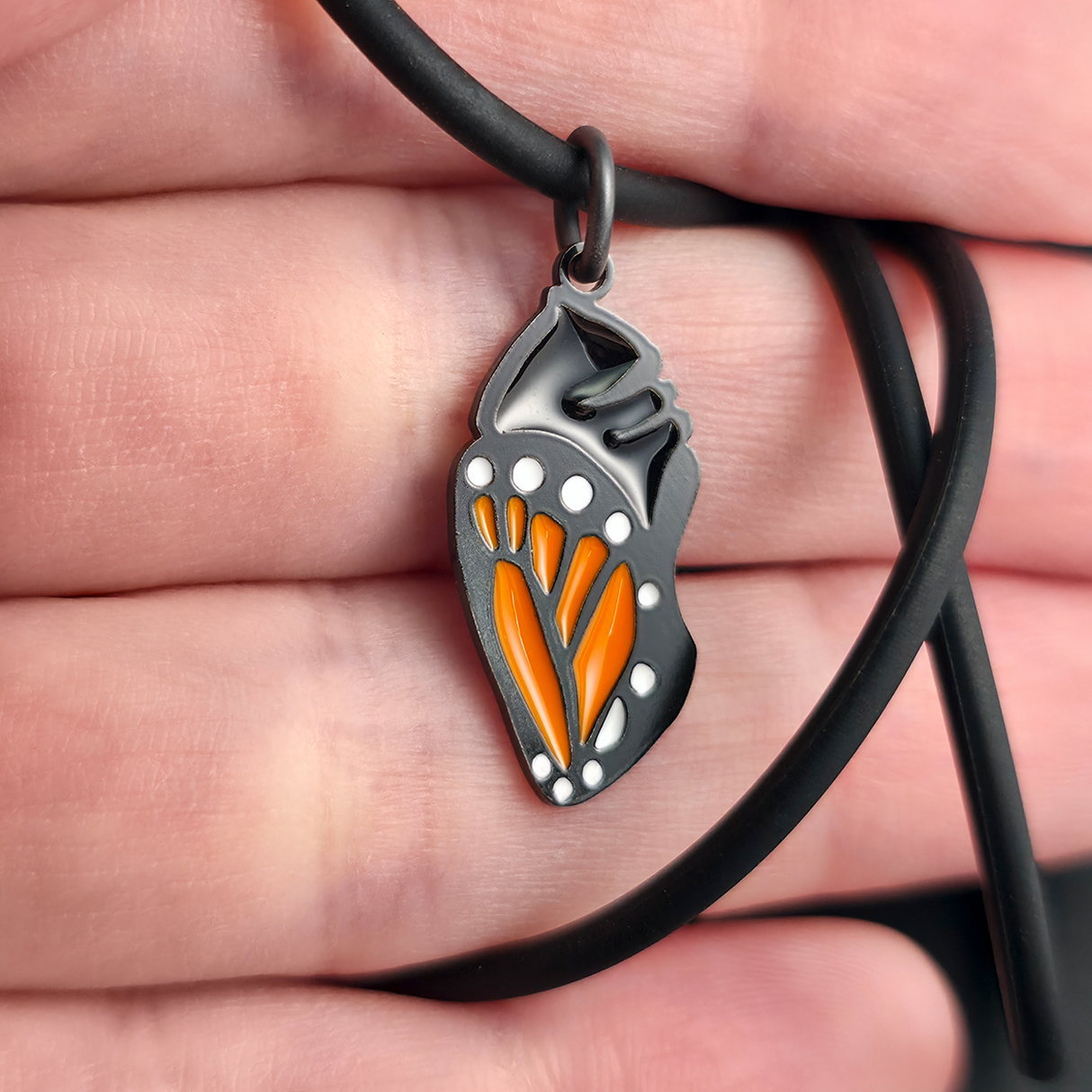 monarch butterfly chrysalis necklace pendant on hand