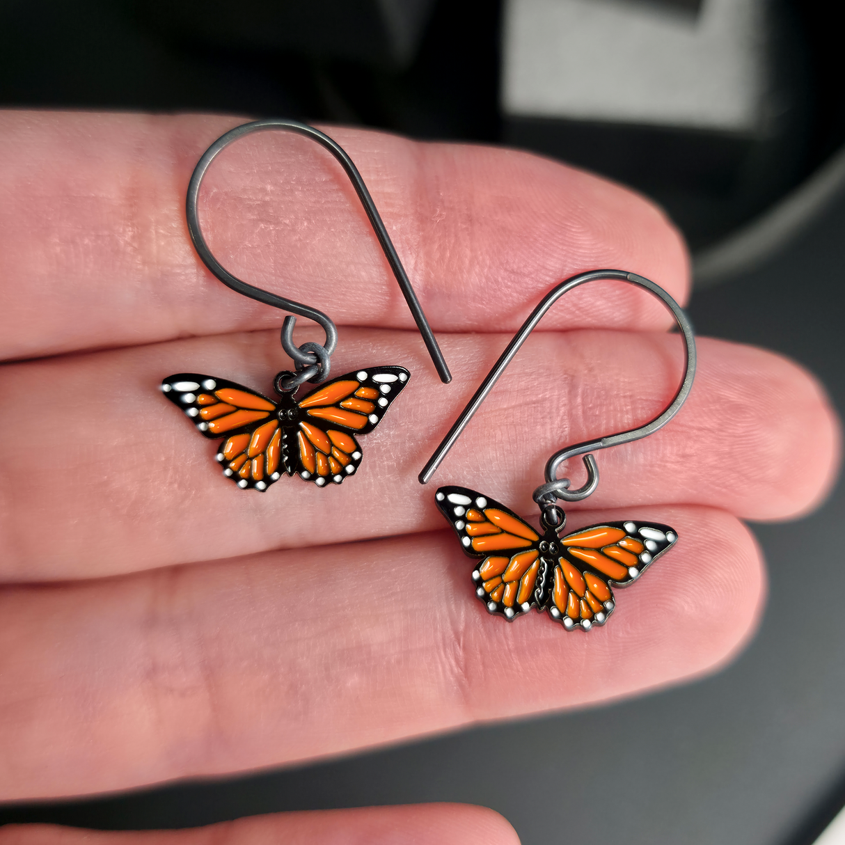 monarch butterfly dangle earrings on hand