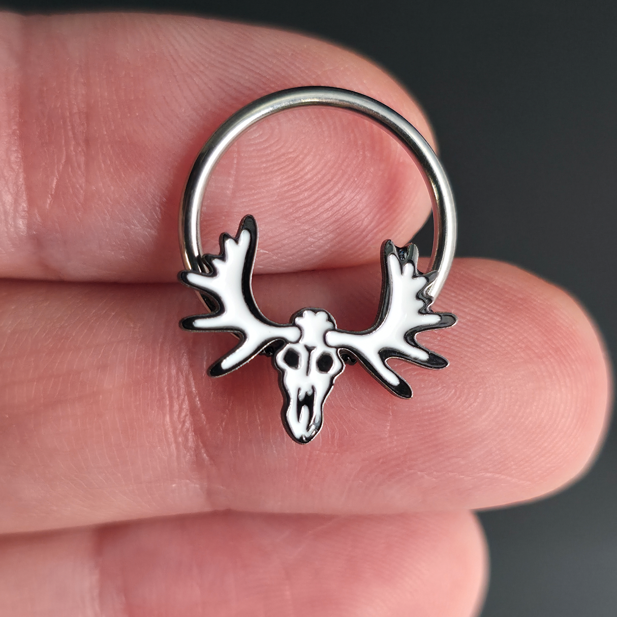 moose skull septum ring on hand