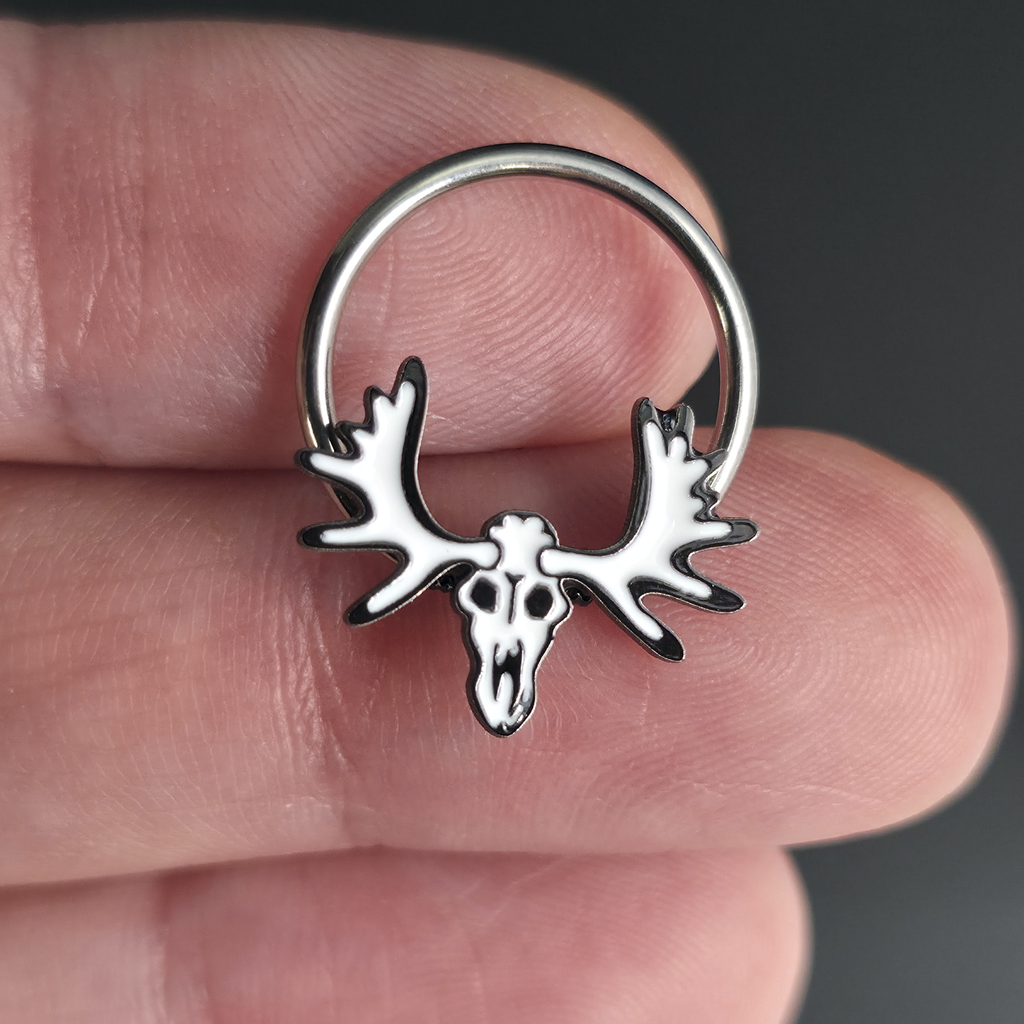 moose skull septum ring on hand