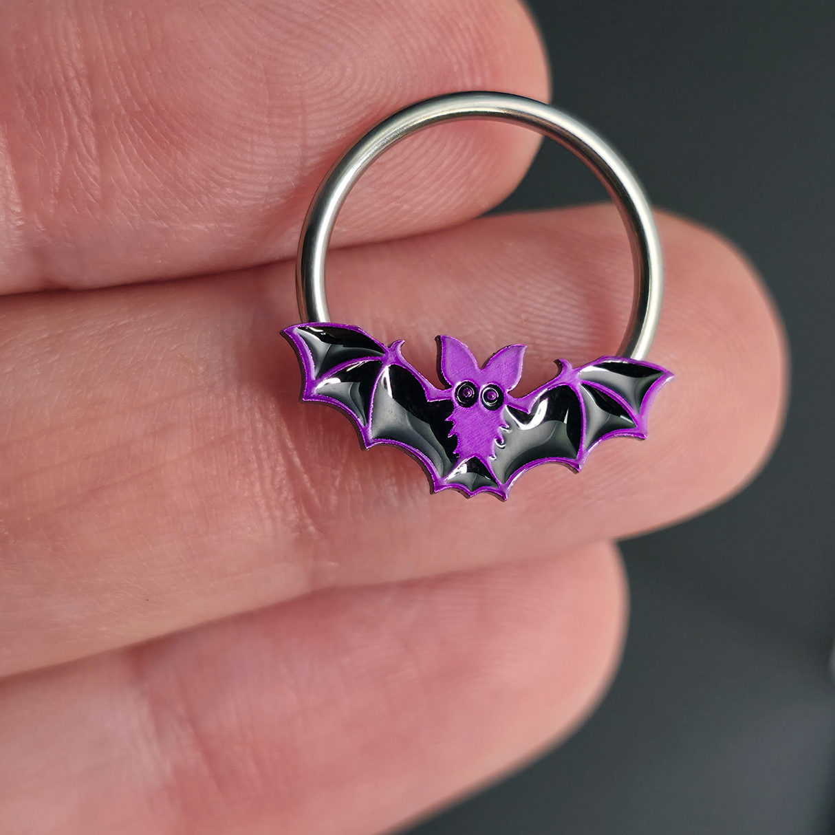 purple halloween bat septum ring on hand