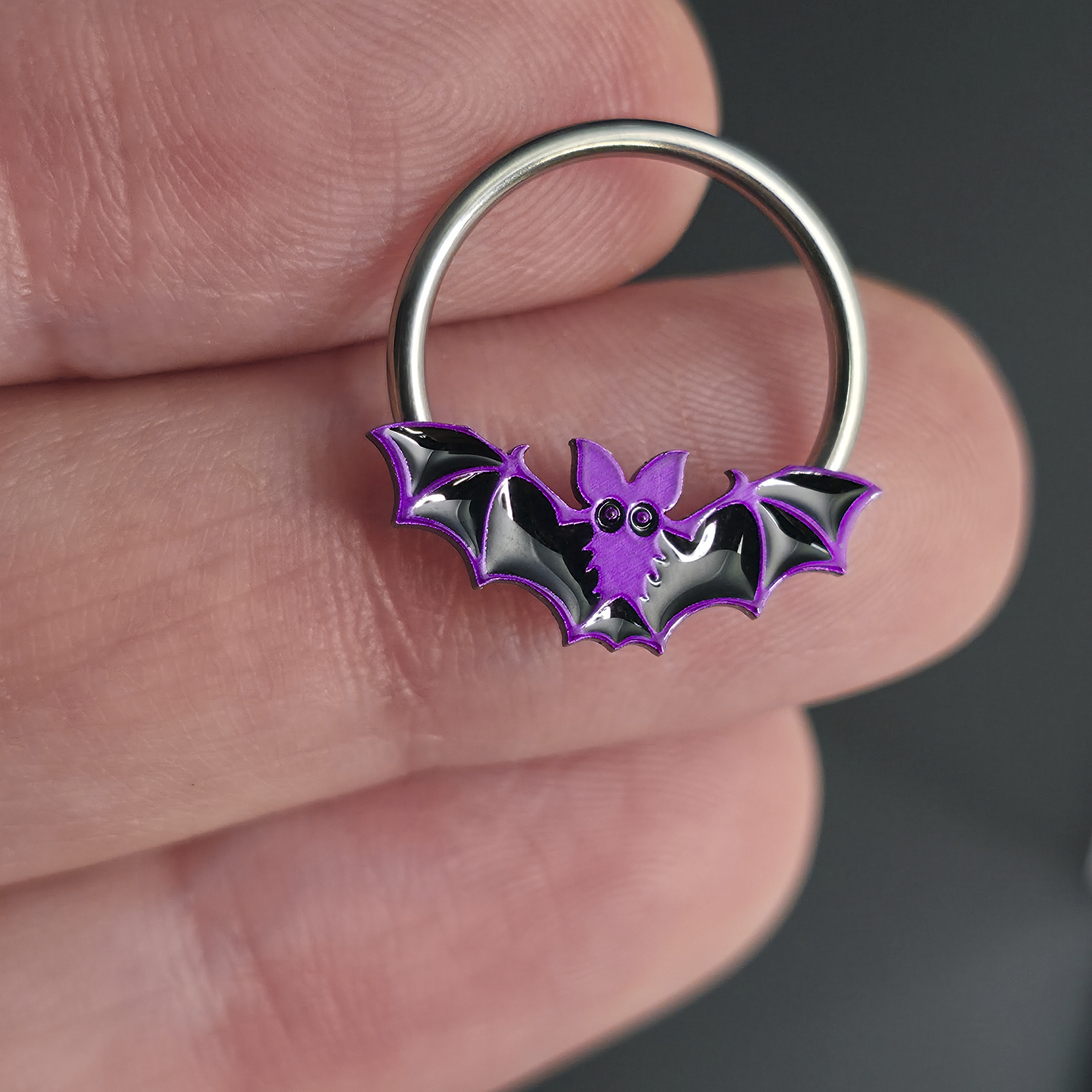 purple halloween bat septum ring on hand