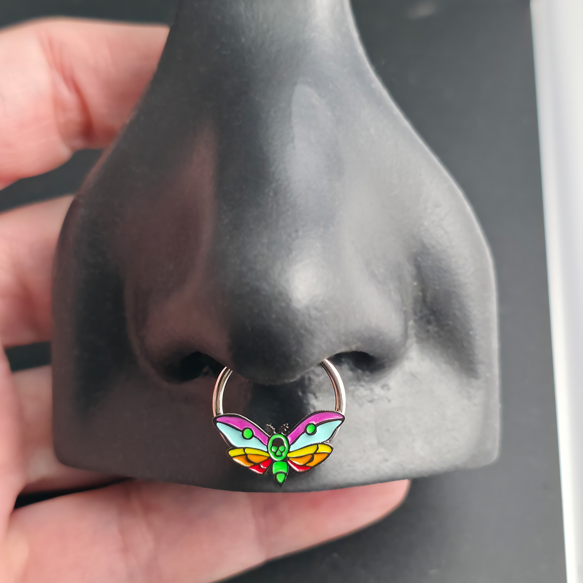 rainbow death moth septum ring in nose