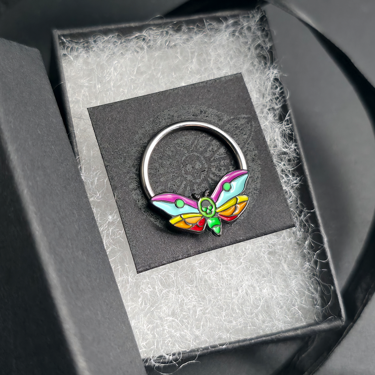 rainbow death moth septum ring in jewelry box