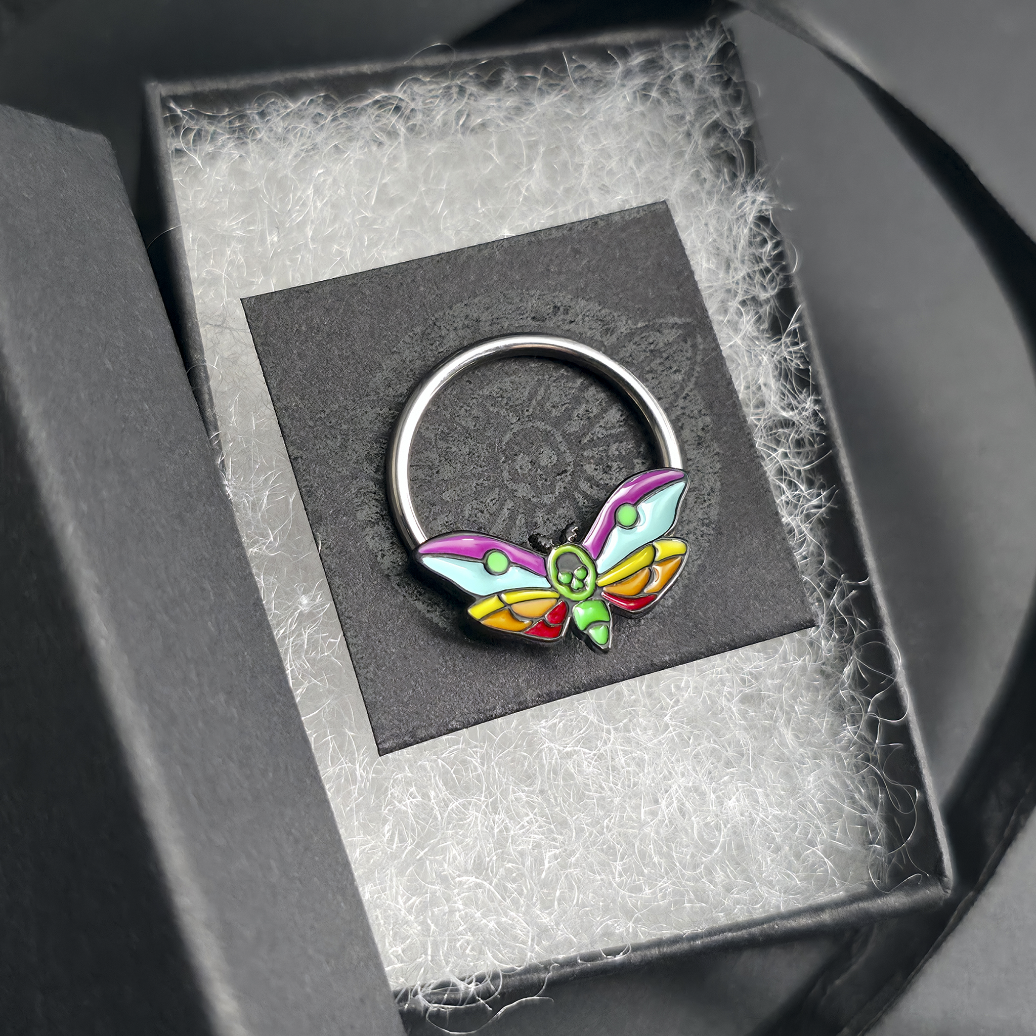 rainbow death moth septum ring in jewelry box