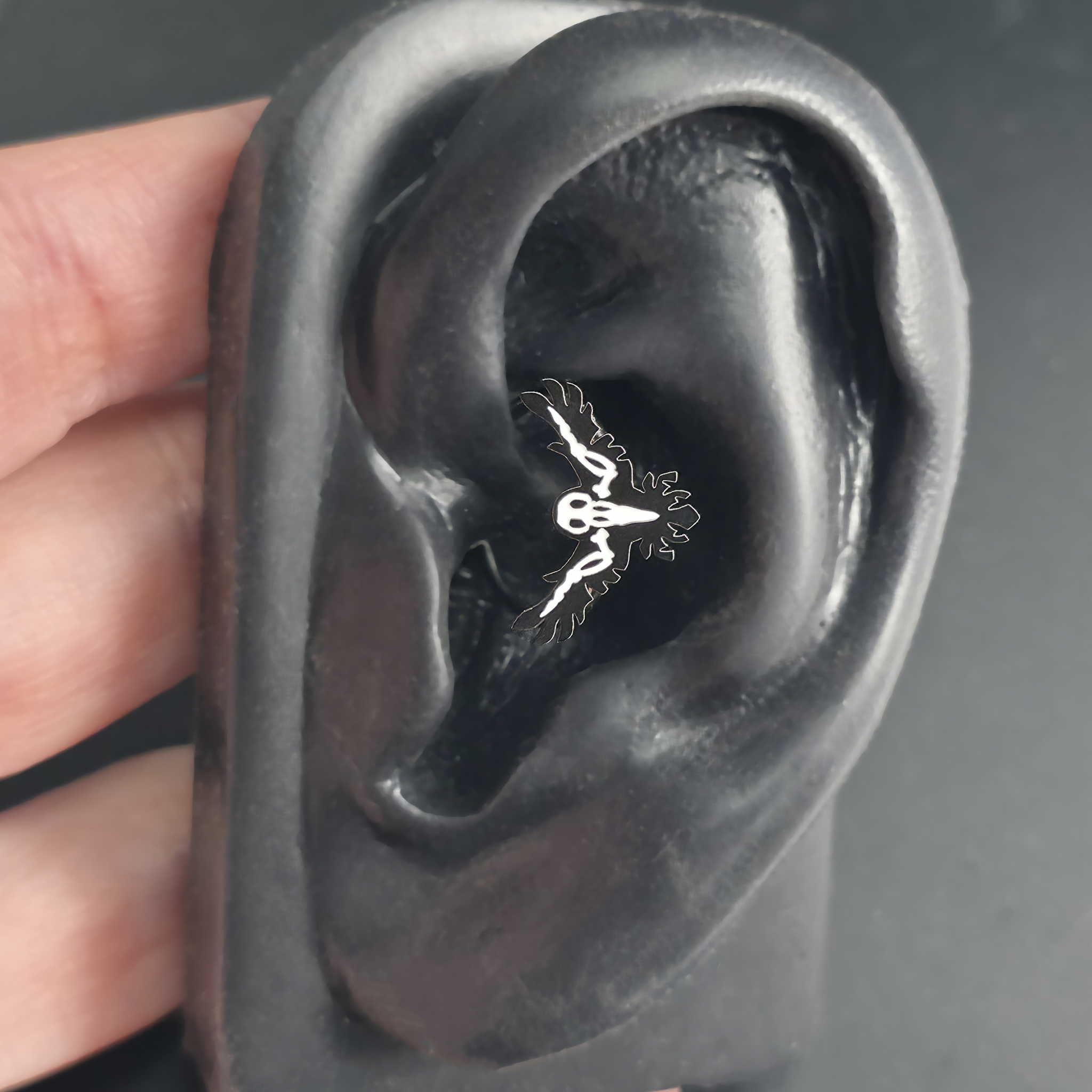 raven skeleton daith earring in ear