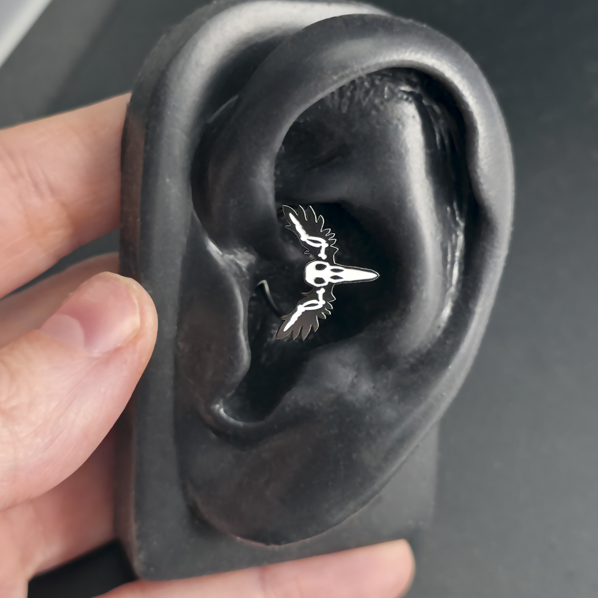 raven skull daith earring in ear