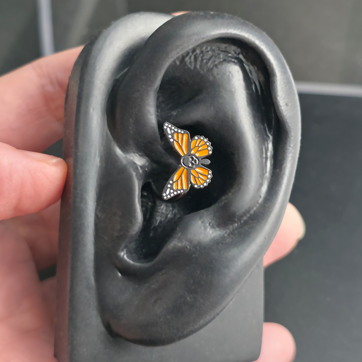 skull butterfly daith earring in ear