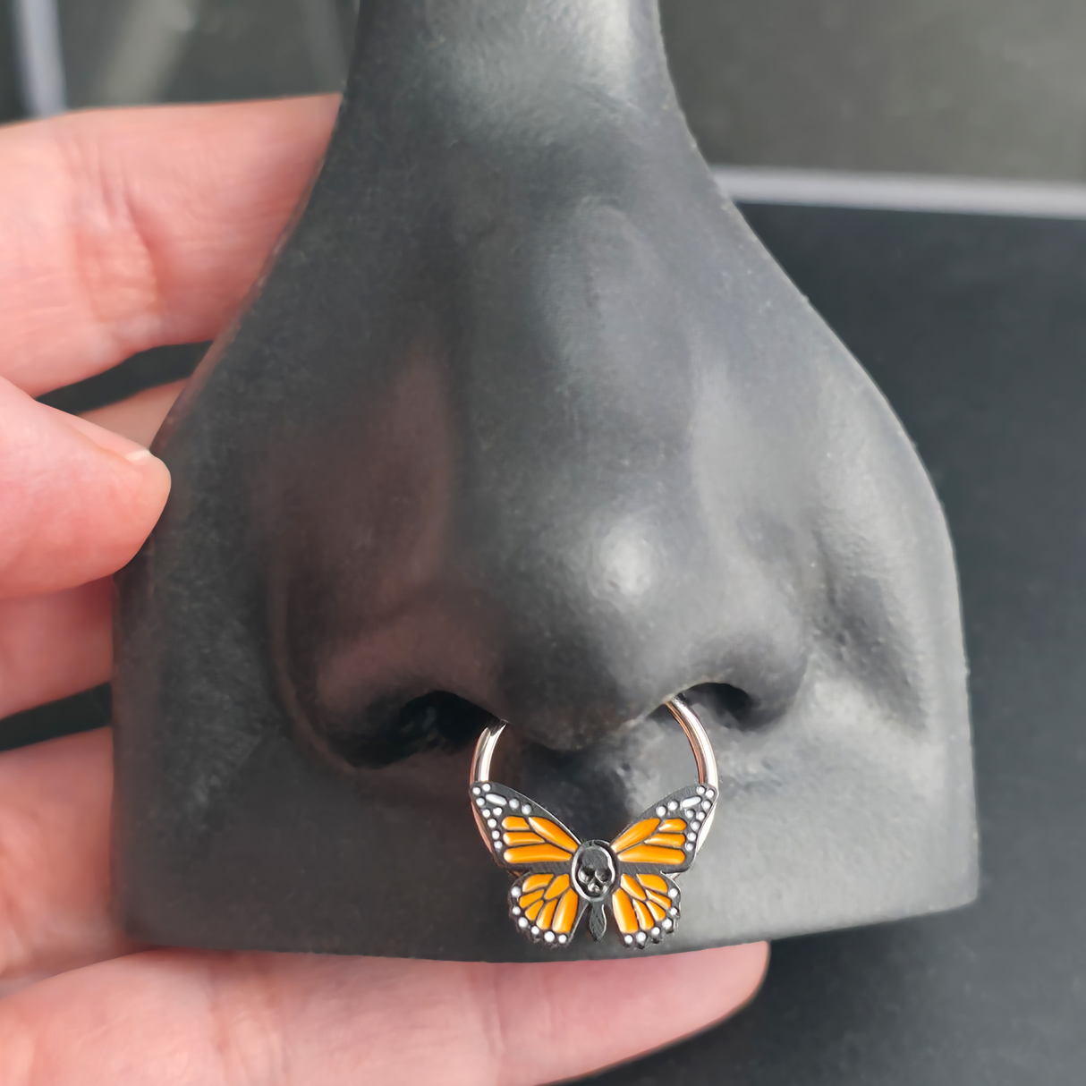 skull butterfly septum ring in nose