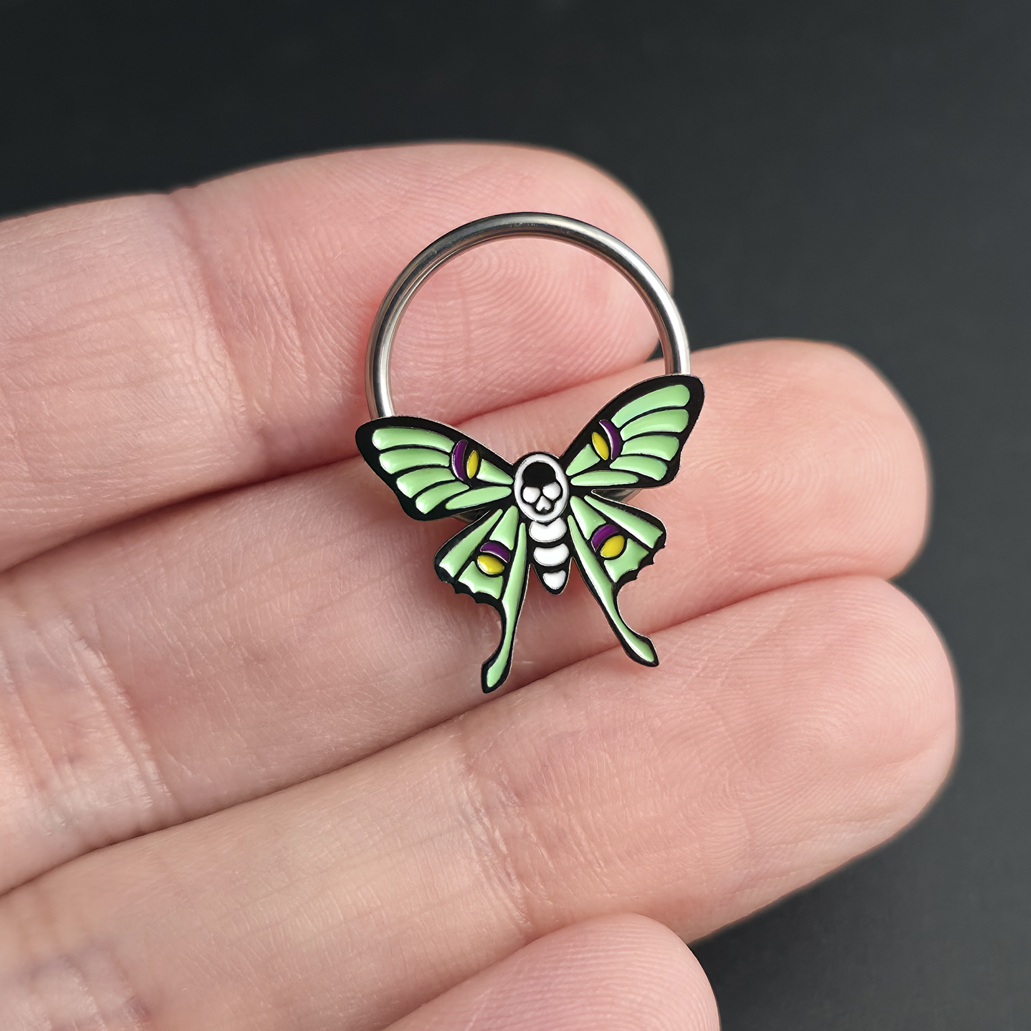 skull luna moth septum ring on hand