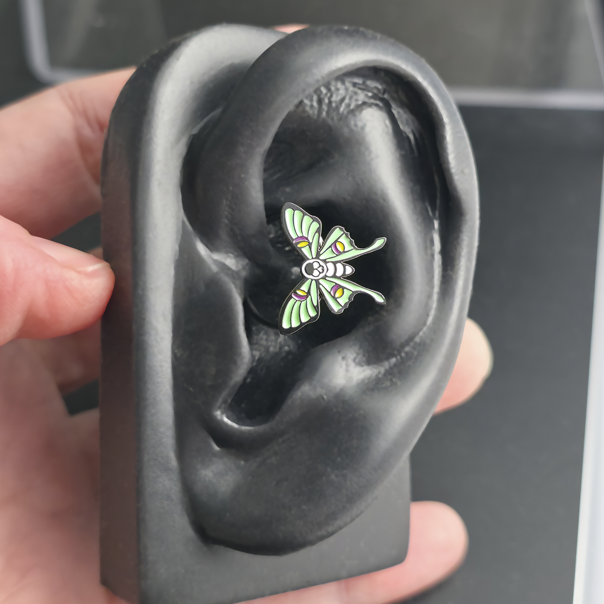 skull luna moth daith earring in ear