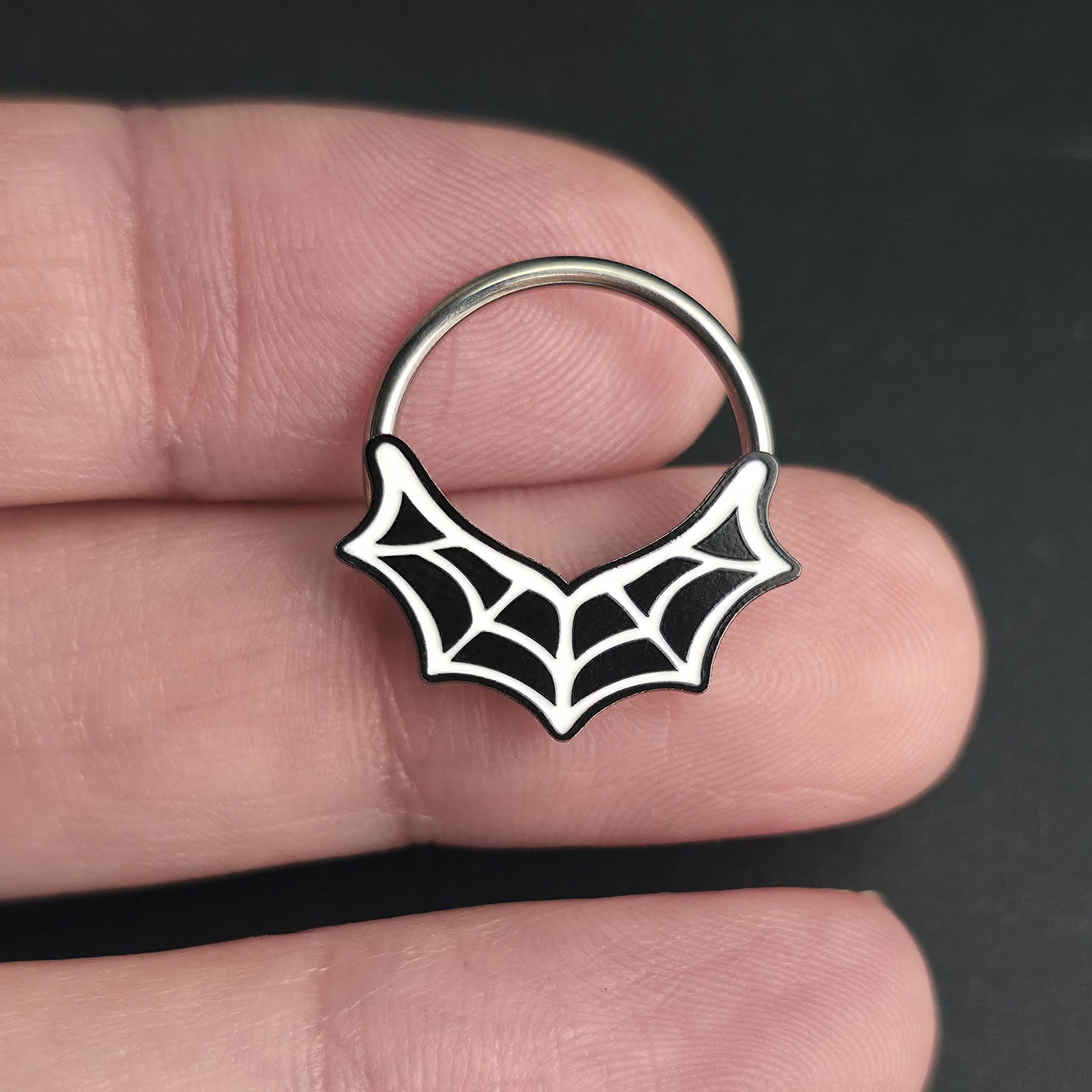 spiderweb septum ring on hand
