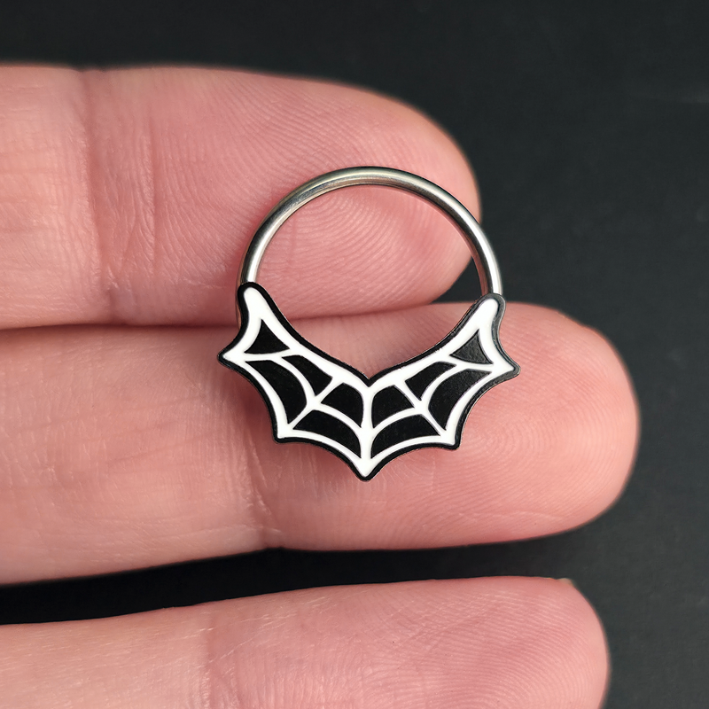 spiderweb septum ring on hand