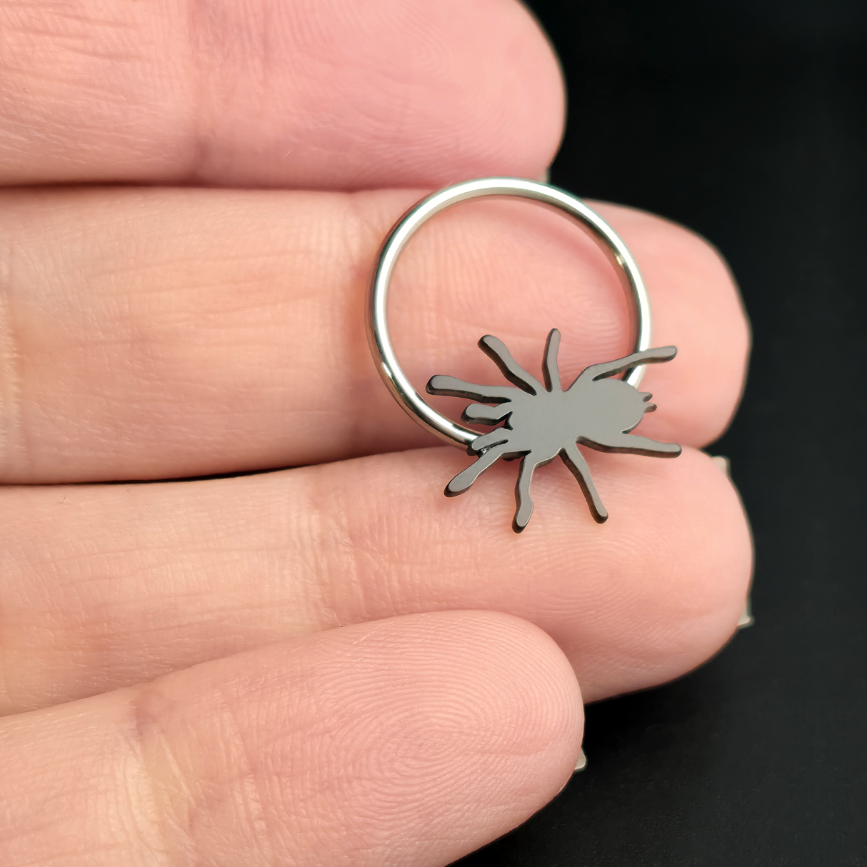 tarantula captive bead ring on hand