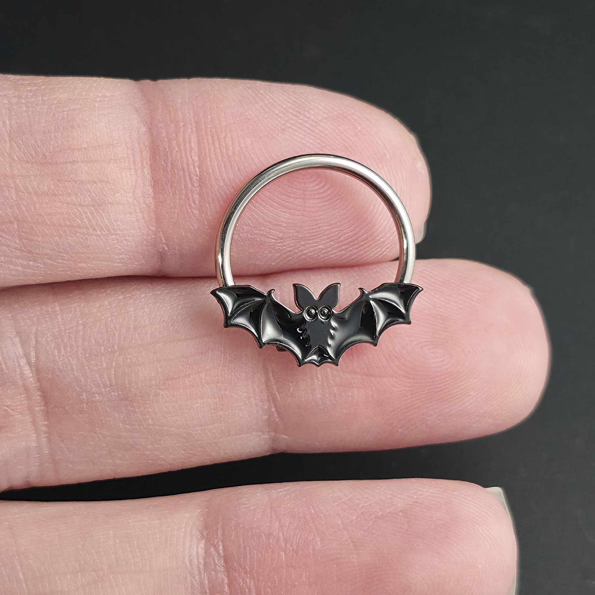 black halloween bat septum ring on hand