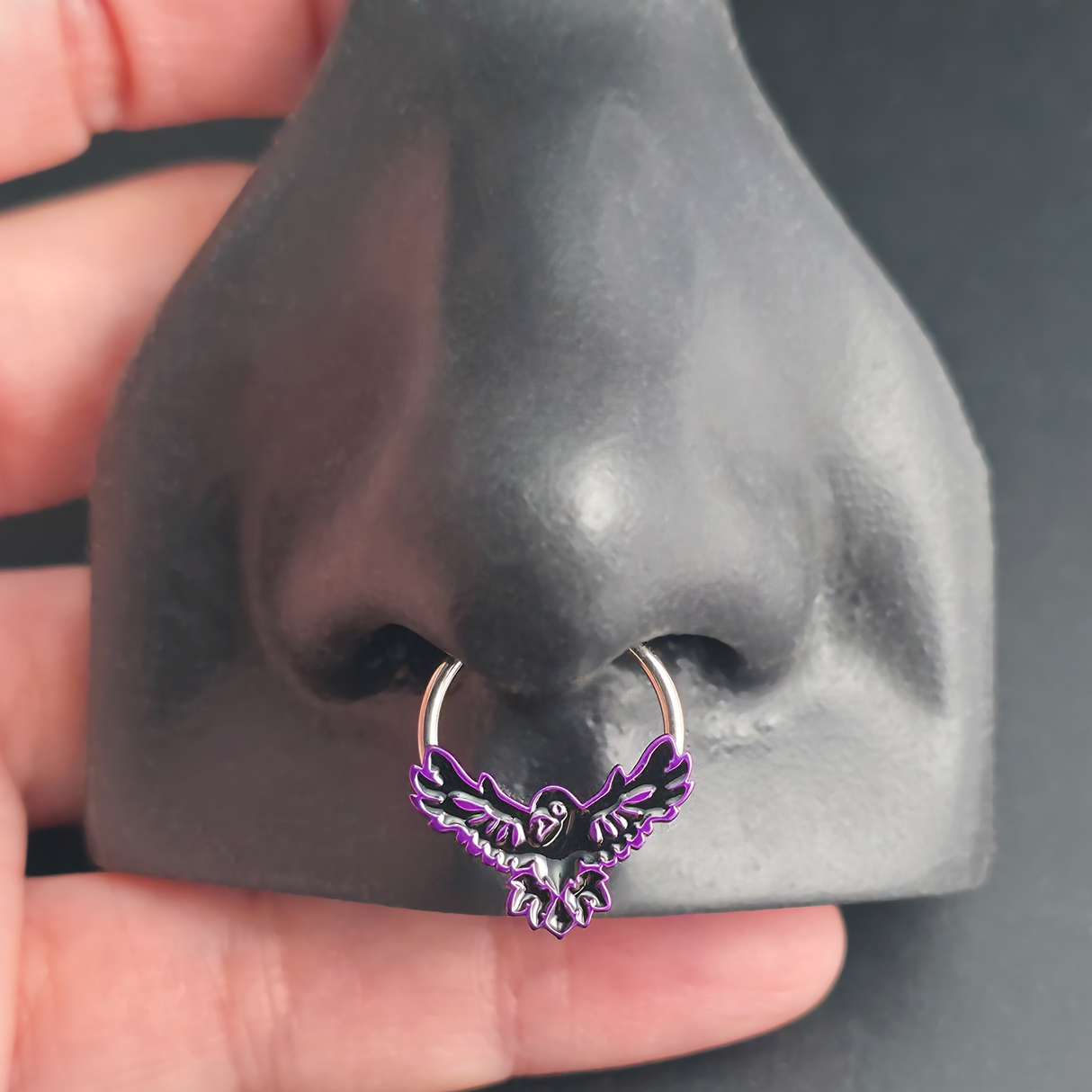flying raven septum ring in nose