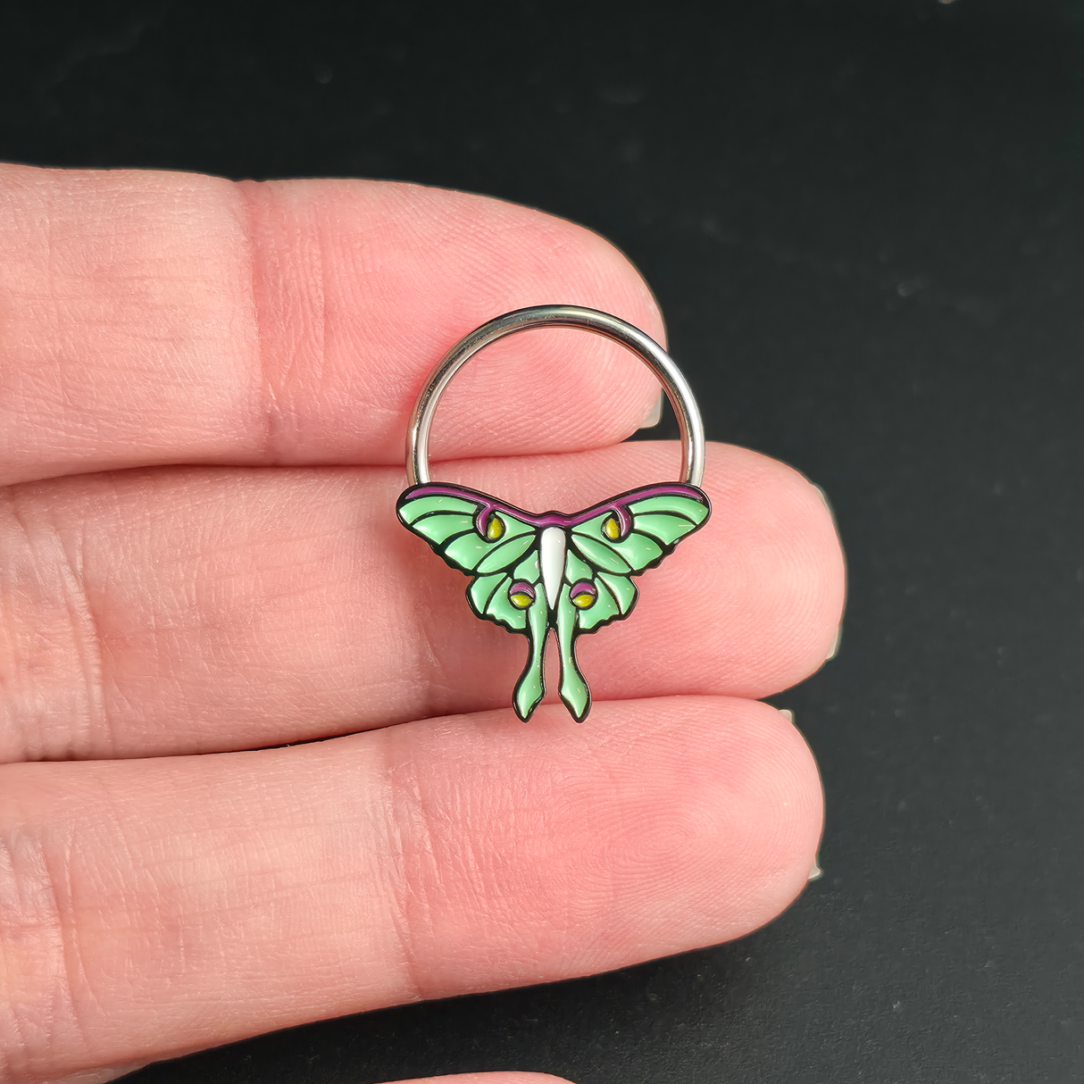 luna moth septum ring on hand