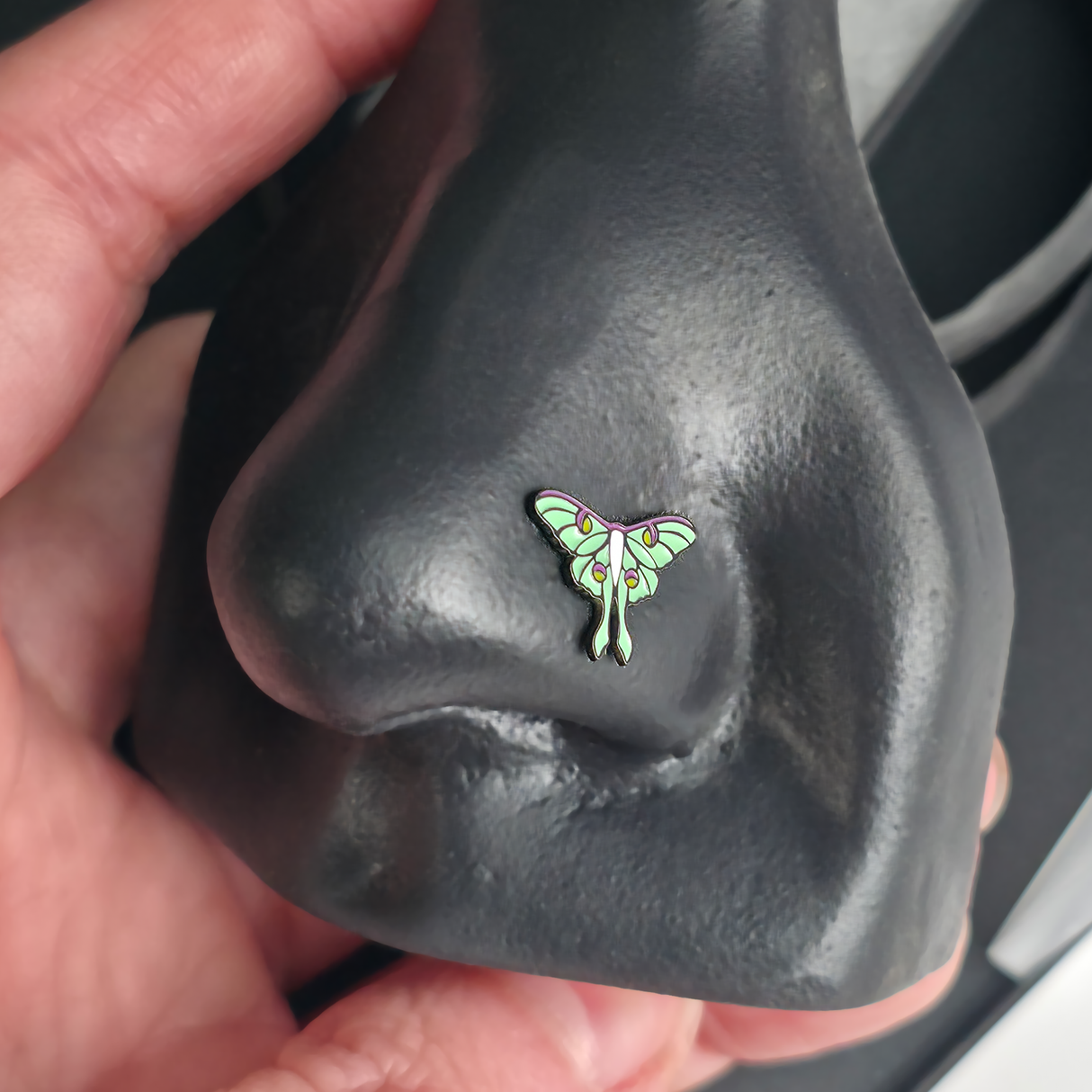 luna moth nose stud in a nose piercing