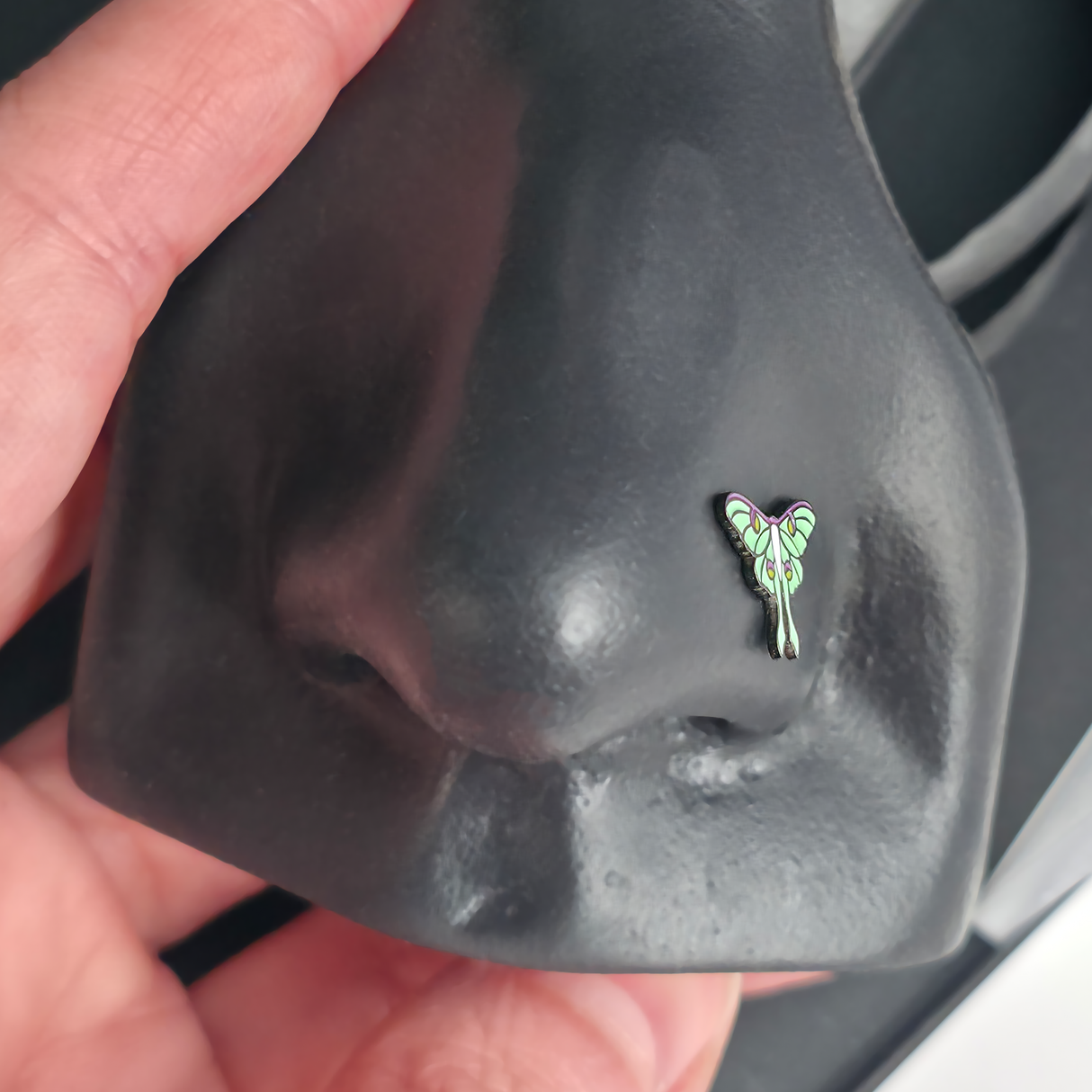 luna moth nose stud in a nose piercing