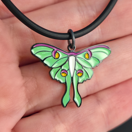 luna moth necklace on hand