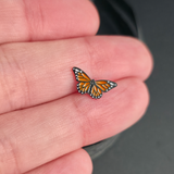 monarch butterfly nose stud and earring on a hand for size reference