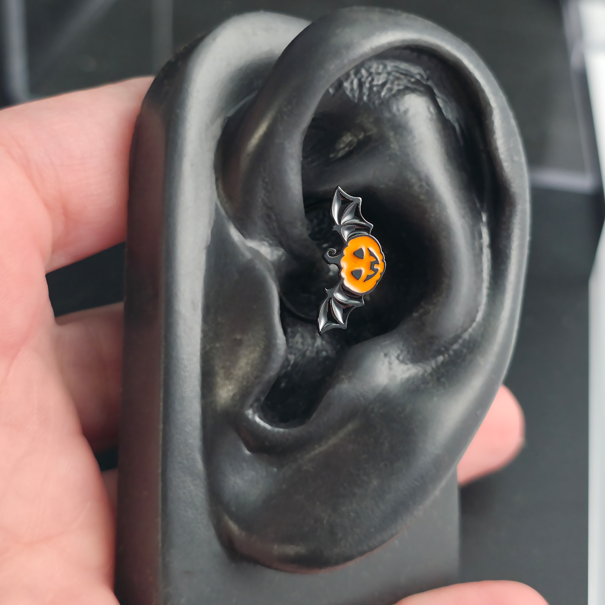 halloween pumpkin bat daith earring in ear