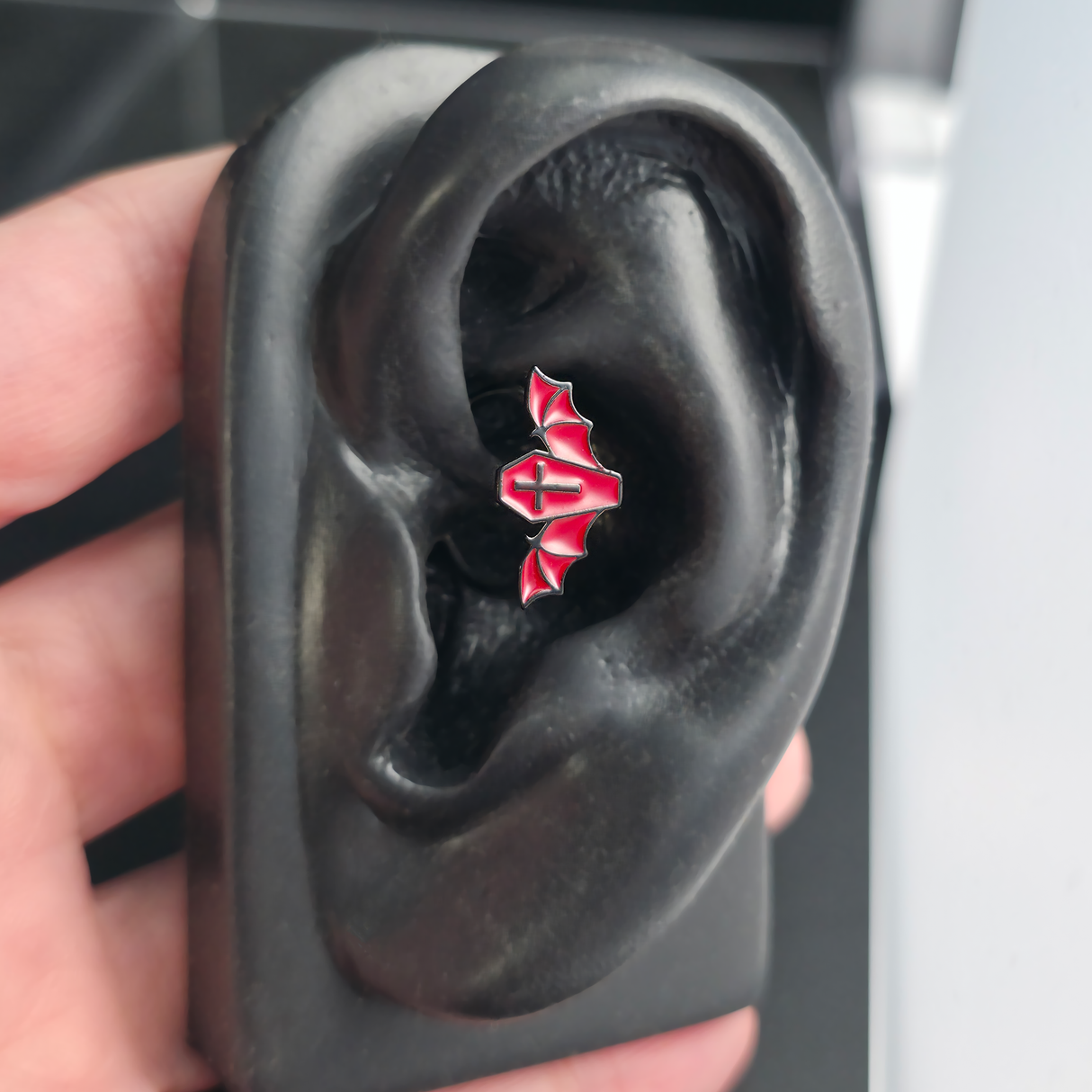 red coffin bat caith earring in ear