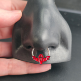 red coffin bat septum ring in nose