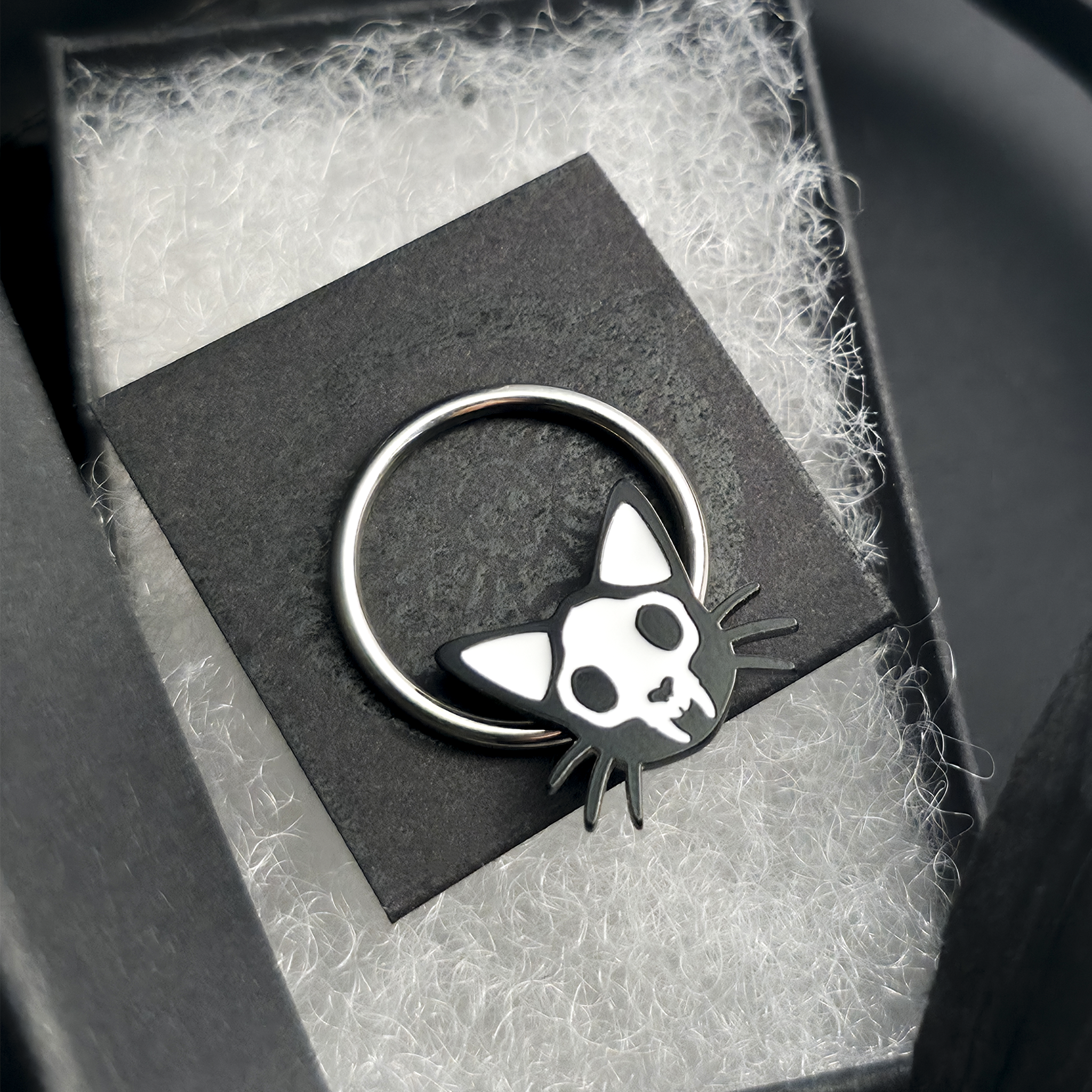 cat skull septum ring in jewelry box