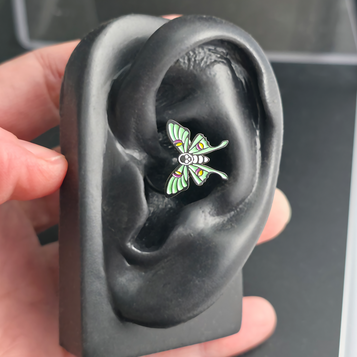 skull luna moth daith earring in ear