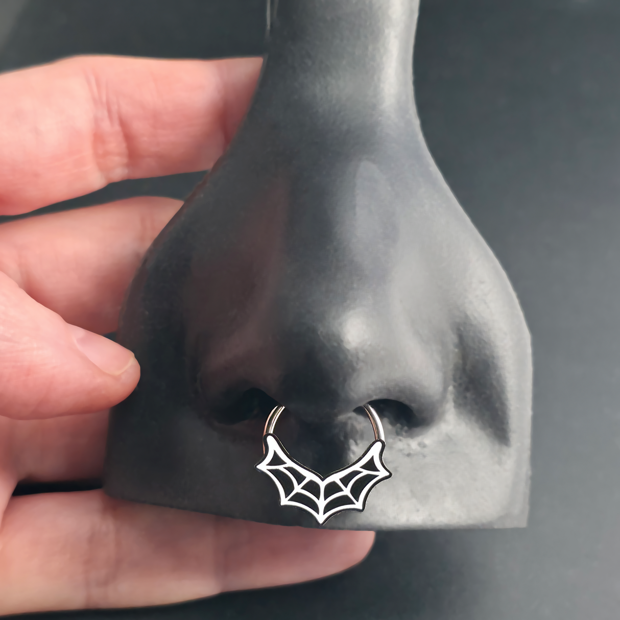 spiderweb septum ring in nose